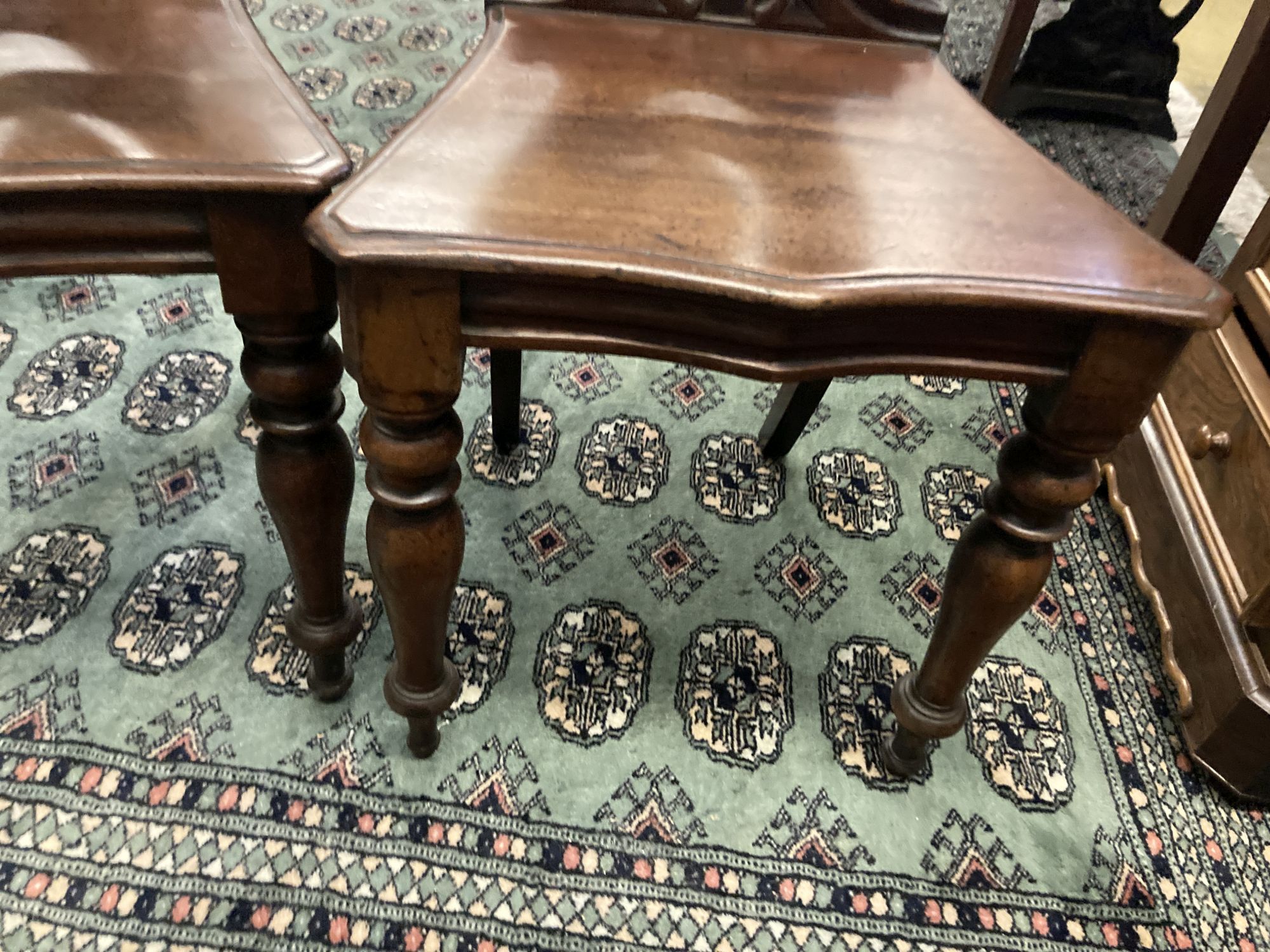 A pair of Victorian mahogany hall chairs